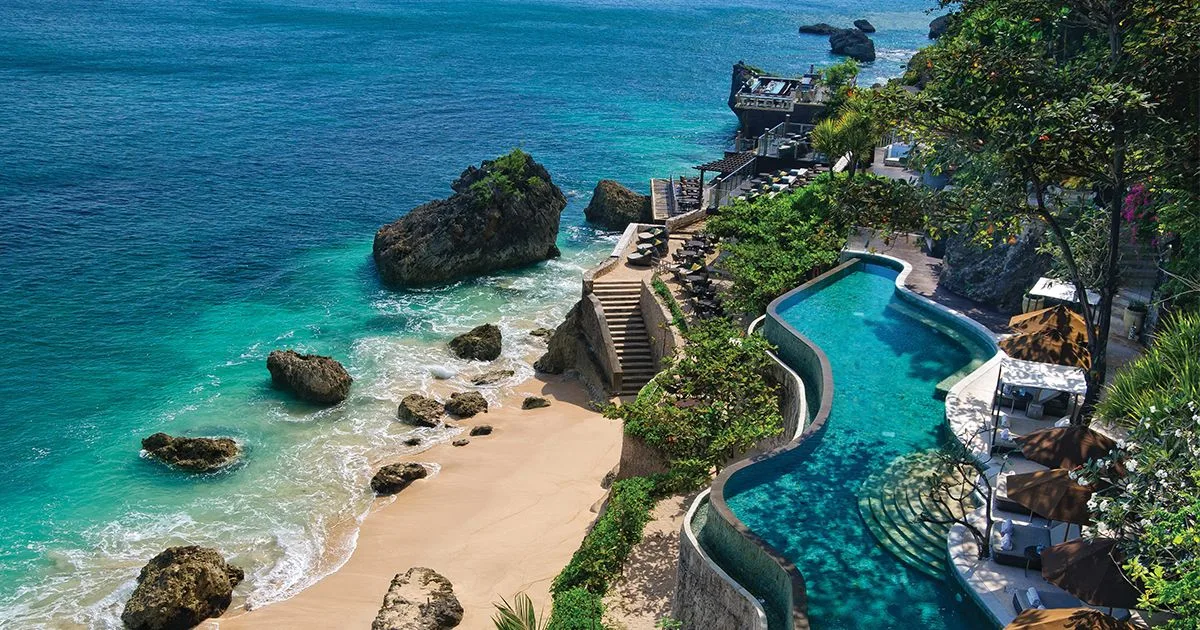 Clifftop pool terrace above a turquoise bay in Bali